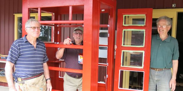 Roger Sexton, Joe Pannett (painting) and Michael Cox in the throes of restoring the second phone box. 